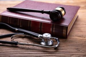 Stethoscope with Mallet And Law Book